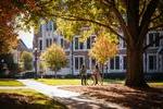 Move to four female students walking on campus slide